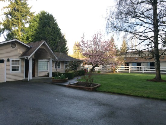 The house with the stables in the background